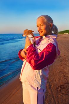 Young woman with her dog on a beach