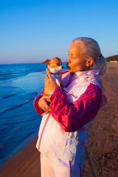 Young woman with her dog on a beach