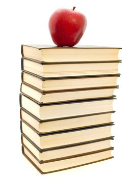 red apple at the top of books stack