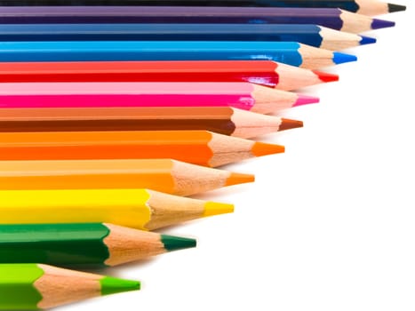 row of coloured pencils over the white background