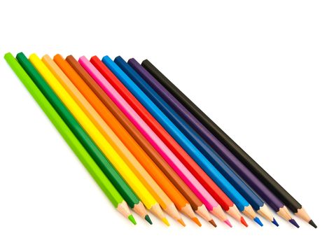 row of coloured pencils over the white background