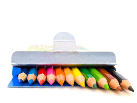 row of coloured pencils over the white background