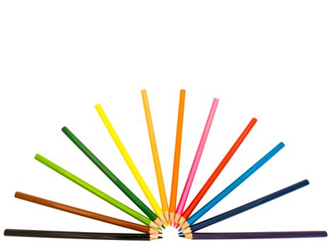 row of coloured pencils over the white background