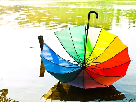 multicolored umbrella at the water