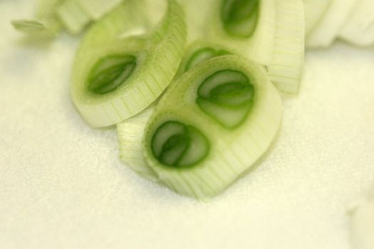 Sliced green onions on a white background