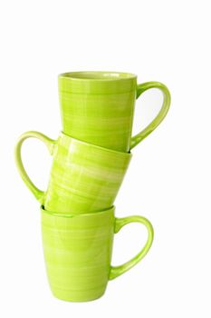 Three green coffee mugs stacked and isolated on a white background.
