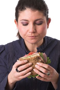 Pretty brunette focused completely on her healthy tasty sandwich, ready to take a bite