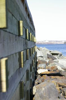 A side view of a boardwalk along a rocky shore line