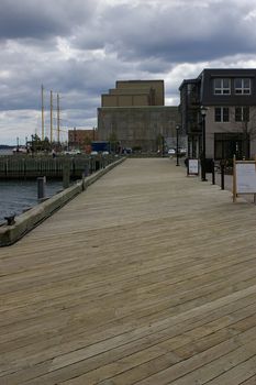 A view down the boardwalk with the water on one side and buildings on the other