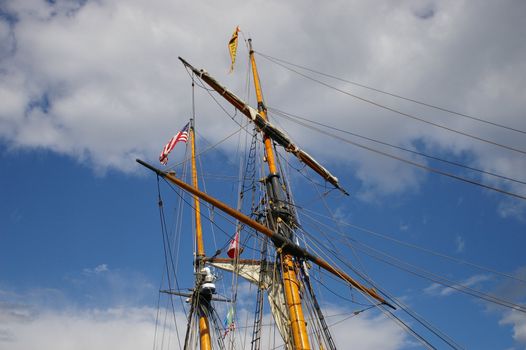 A ships mast reaching high into the sky.