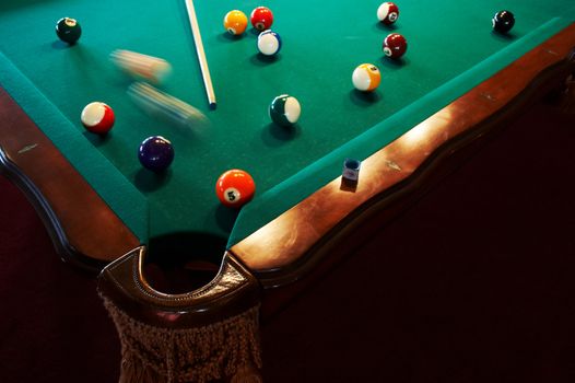 Multi-coloured spheres on a green billiard table