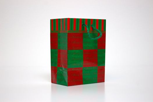 A red and green gift bag on a white background