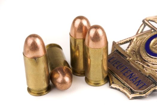 45 caliber bullets and police badge