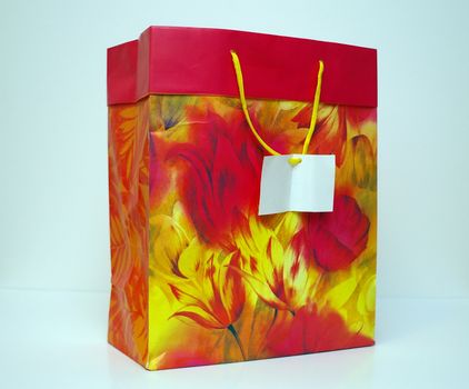 A large gift bag for Christmas or birthday gifts with a blank card on the handle.