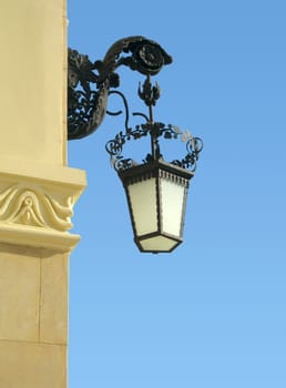 old-fashioned wall lamp with blue sky as background