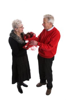 Pretty elderly couple giving flowers for valentines day