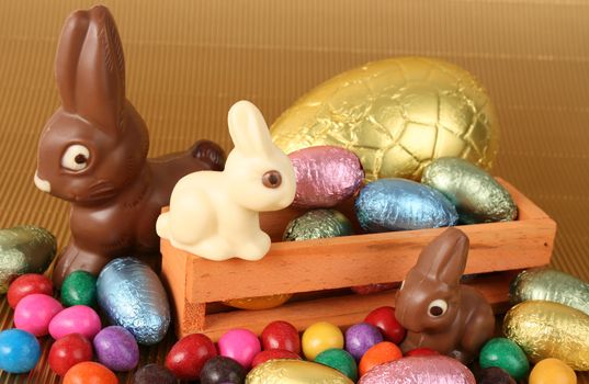 Various colors and shaped easter eggs on a gold background