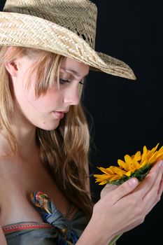 Beautiful young female model holding a sunflower