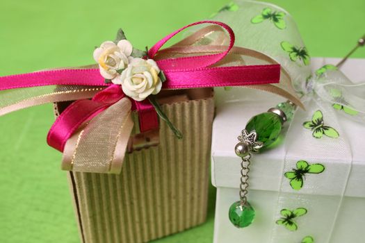 White gift box and small brown gift bag with ribbons