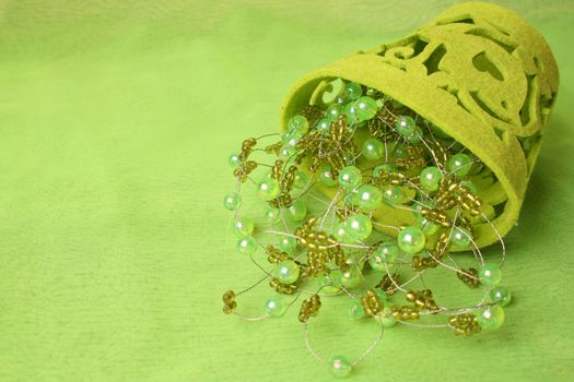 Green beads on wire in a soft container