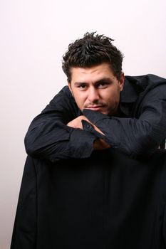 Male model in studio against white wall