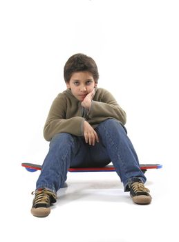 Cool boy sitting on a skate. Full body, white background. More pictures of this model at my gallery
