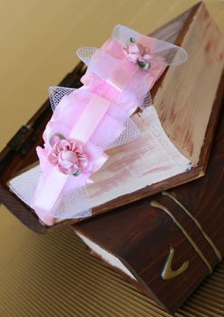 Pink Hair Accessories on a woonden jewellery box, on a golden background
