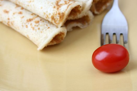 Barbeque Chicken Pancakes with a single tomato
