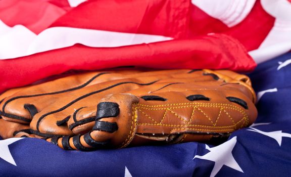 An abstract photograph of a baseball glove and an American flag.