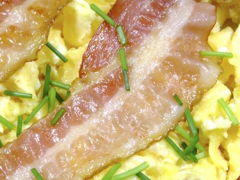 Close-up of scrambled eggs with bacon strips