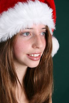 Brunette Teenager wearing a fluffy christmas hat