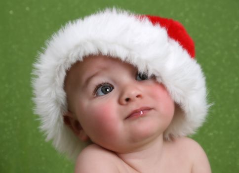 Dreamy Christmas image of a baby looking into the distance