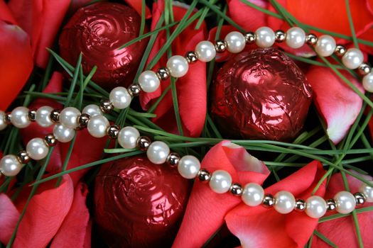 Valetines day pearls with chocolates and petals