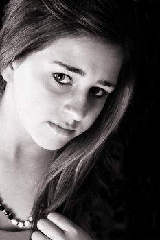 Beautiful teenage female against a black background