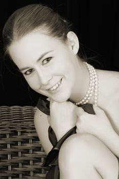 Beautiful female wrapped in fabric, wearing pearls 