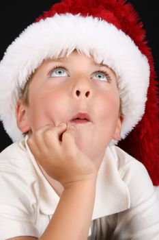 Cute christmas boy with beautiful blue eyes looking up