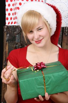 Beautiful blond female holding a christmas present