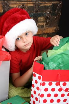 Little boy with big blue eyes wearing a christmas hat 