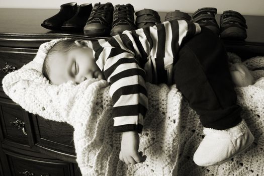 Month old baby boy sleeping in a drawer