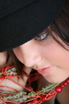 Close-up of a beautiful brunette teen wearing a hat