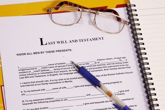 last will and testament form with notebook and pen.
