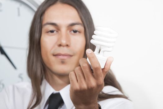 Handsome young man holding energy efficient lightbulb