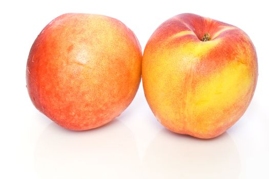 two fresh ripe nectarines isolated on white background