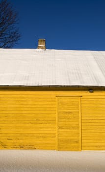 yellow winter house fragment and snow