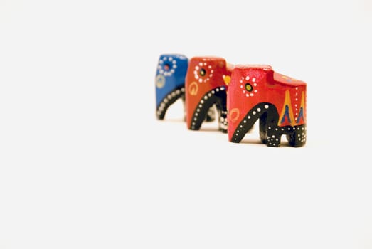 three little wooden african color elephants