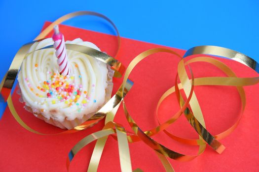 Birthday Cupcake with one candle and gold ribbon