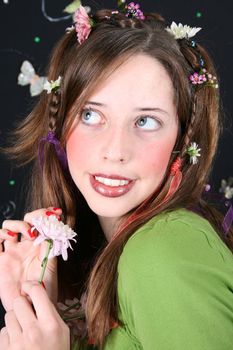 Teenage model with flowers and butterflies in her hair