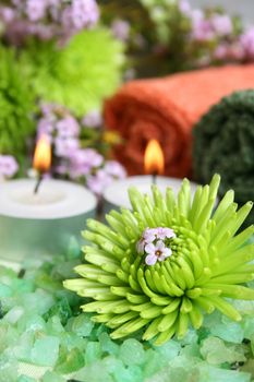 Spa Accessories setting with face cloths, candles and flowers