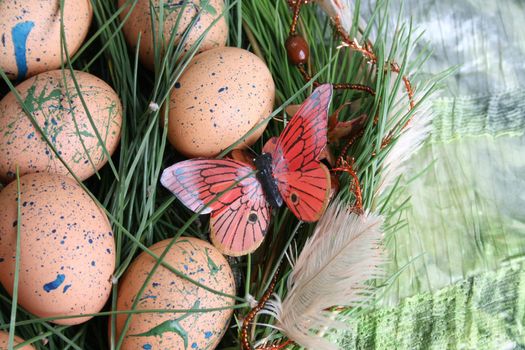 Decorated eggs in a wreath on a green background
