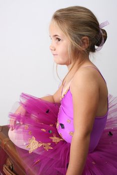 Young girl wearing a tutu dreaming of becoming a ballet dancer